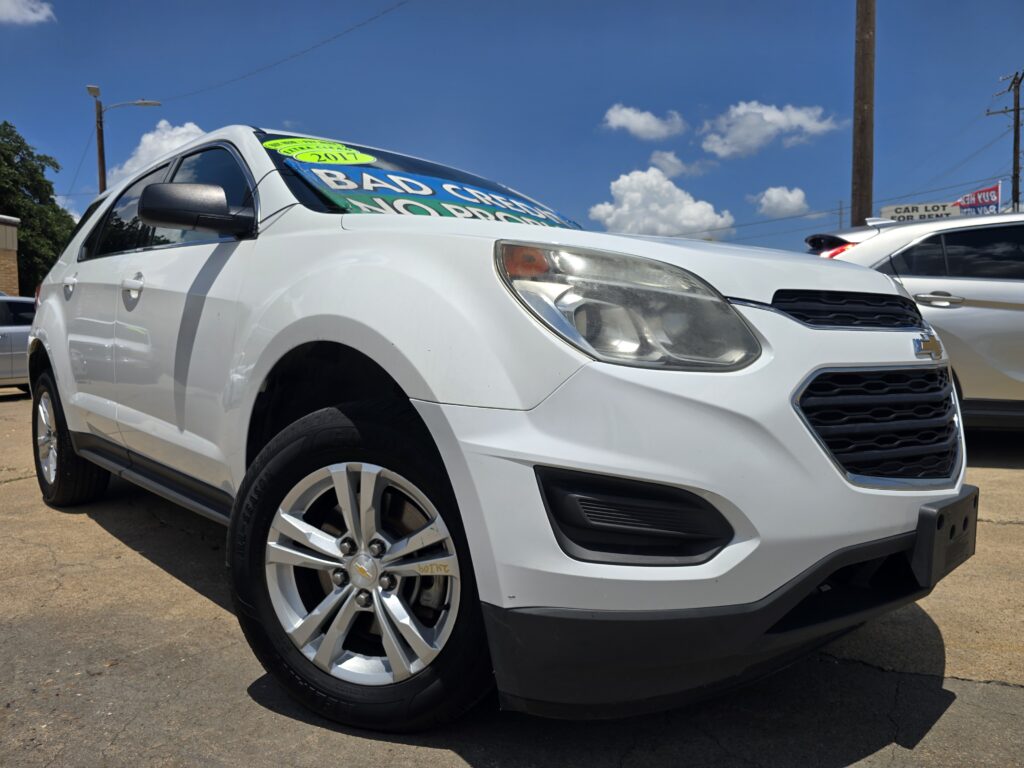 White Chevrolet SUV on a dealership lot with a bright green 2017 sign visible in the windshield.