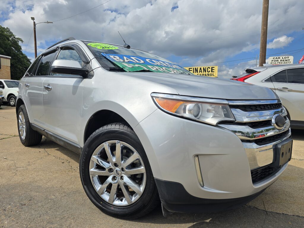 Silver SUV on a dealership lot with a large windshield banner advertising financing options.