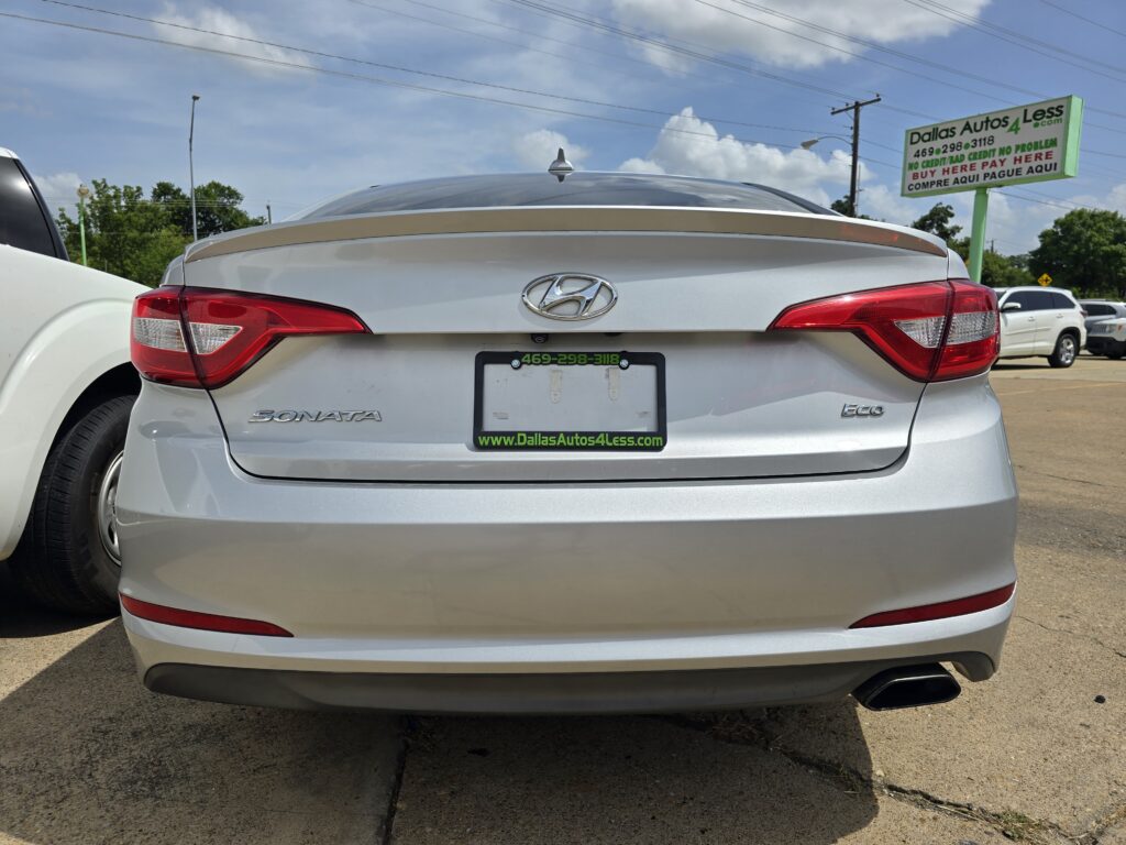 Rear view of a silver Hyundai Sonata Eco with a Dallas Autos 4 Less dealer plate frame